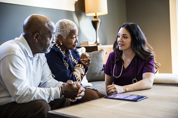 A doctor speaking to a senior couple