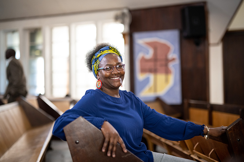 woman in a blue shirt sitting in church