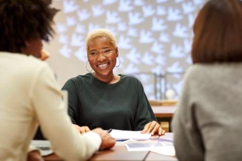 woman at a meeting smiling