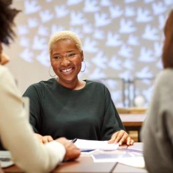woman at a meeting smiling