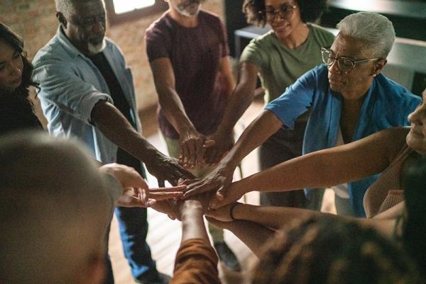 circle of people joining hands