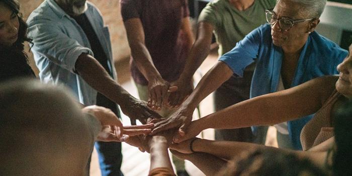 circle of people joining hands