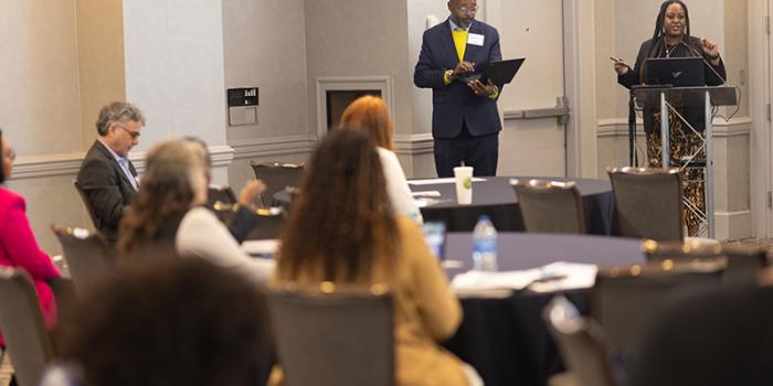 People listening to a speaker at a conference